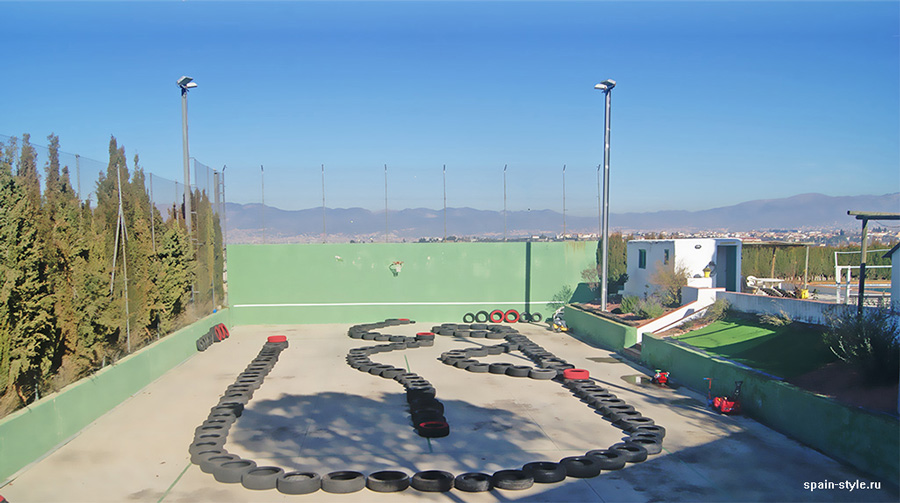 A track easily adaptable for tennis courts or basketball and volleyball courts